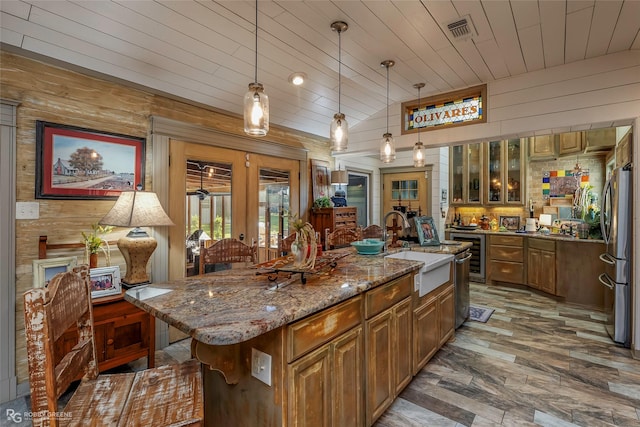 9900 Myrtis Texas Line Rd, Vivian, LA 71082 - kitchen featuring wooden ceiling, wood walls, beverage cooler, a kitchen island with sink, and light stone countertops