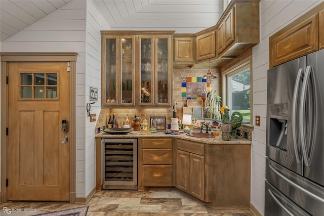 9900 Myrtis Texas Line Rd, Vivian, LA 71082 - indoor wet bar featuring stainless steel refrigerator with ice dispenser, wine cooler, wood walls, vaulted ceiling, and backsplash