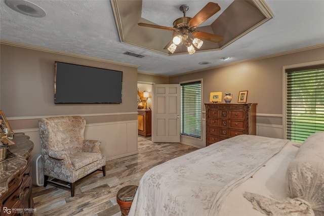 9900 Myrtis Texas Line Rd, Vivian, LA 71082 - bedroom with wood finished floors, crown molding, wainscoting, and ceiling fan