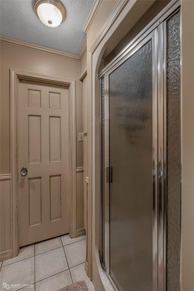 9900 Myrtis Texas Line Rd, Vivian, LA 71082 - bathroom featuring crown molding, a shower stall, tile patterned floors, and a textured ceiling