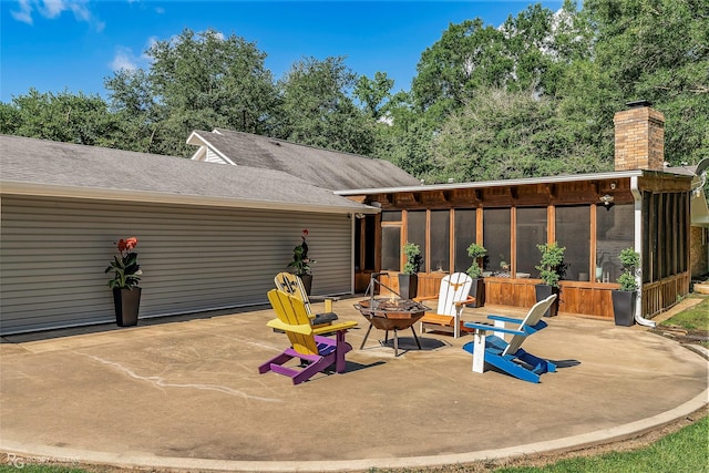 9900 Myrtis Texas Line Rd, Vivian, LA 71082 - view of patio / terrace featuring a sunroom and a fire pit