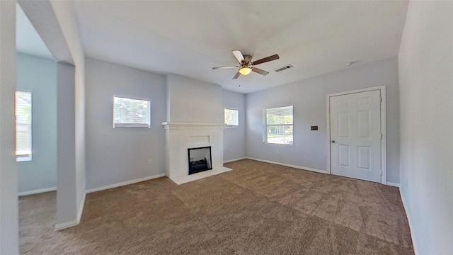 2700 S Jones St, Fort Worth, TX 76104 - unfurnished living room featuring ceiling fan, carpet, and a fireplace with flush hearth