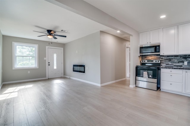 331 Andover Dr, Mesquite, TX 75149 - kitchen with stainless steel appliances, heating unit, tasteful backsplash, white cabinetry, and a ceiling fan