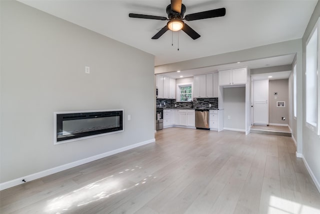 331 Andover Dr, Mesquite, TX 75149 - unfurnished living room with a ceiling fan, light wood finished floors, and a glass covered fireplace