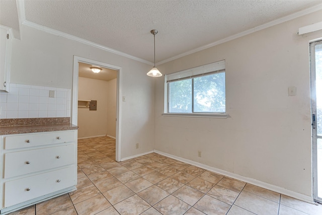 3000 Lambert Dr, Mesquite, TX 75150 - unfurnished dining area featuring a textured ceiling, healthy amount of natural light, crown molding, and light tile patterned floors