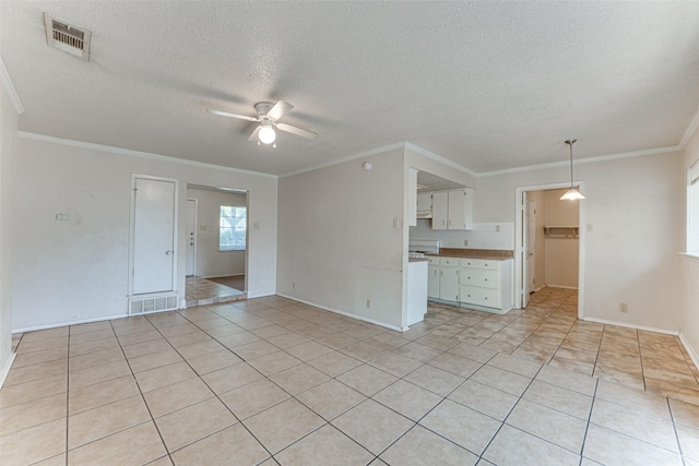 3000 Lambert Dr, Mesquite, TX 75150 - unfurnished living room with ceiling fan, a textured ceiling, light tile patterned floors, and crown molding