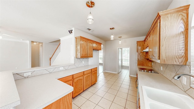 4009 Bickmore Ln, Fort Worth, TX 76244 - kitchen with light countertops, tasteful backsplash, light tile patterned floors, hanging light fixtures, and black cooktop