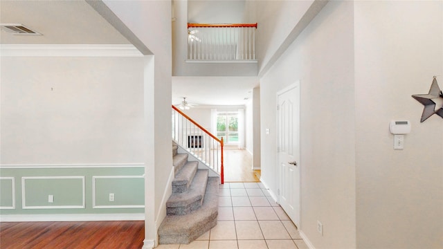 4009 Bickmore Ln, Fort Worth, TX 76244 - entryway featuring stairs, crown molding, a ceiling fan, and light tile patterned floors