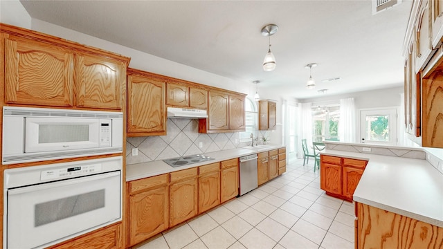 4009 Bickmore Ln, Fort Worth, TX 76244 - kitchen featuring white appliances, decorative backsplash, light countertops, pendant lighting, and light tile patterned floors