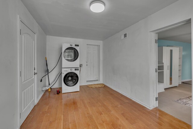 2020 Skylark Dr, Dallas, TX 75216 - washroom featuring stacked washer / dryer and light wood finished floors