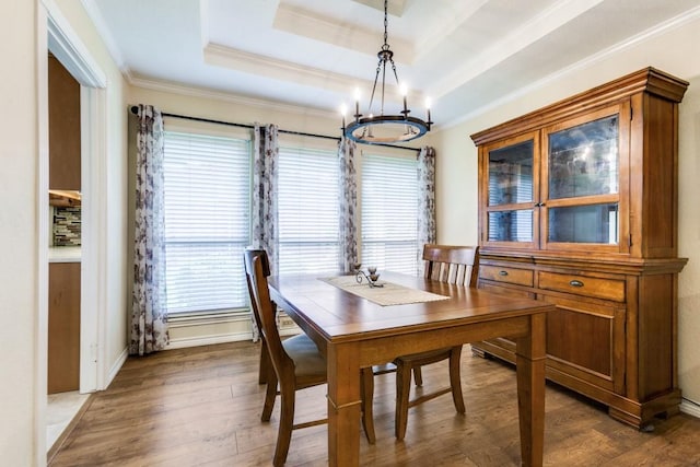 2514 Golden Oaks Dr, Garland, TX 75044 - dining space featuring a chandelier, crown molding, a raised ceiling, plenty of natural light, and wood finished floors