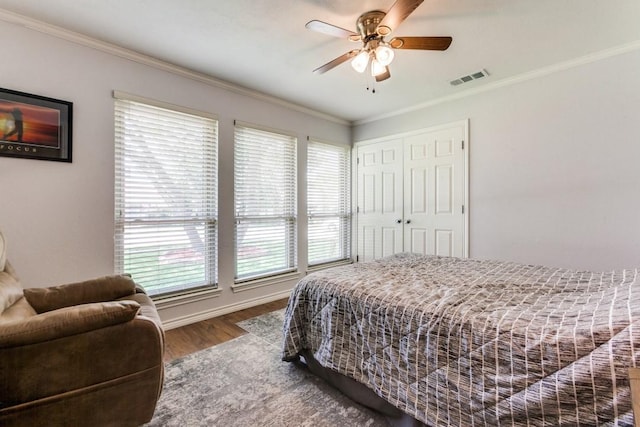 2514 Golden Oaks Dr, Garland, TX 75044 - bedroom with ornamental molding, wood finished floors, a ceiling fan, and a closet