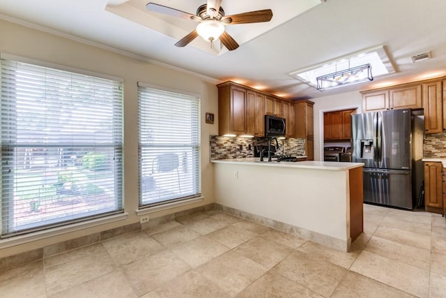 2514 Golden Oaks Dr, Garland, TX 75044 - kitchen featuring stainless steel fridge, backsplash, plenty of natural light, and crown molding