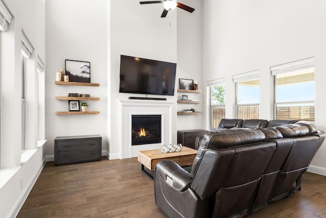 2817 Buckthorn Rd, Northlake, TX 76226 - living room with a high ceiling, ceiling fan, a glass covered fireplace, and dark wood-style floors