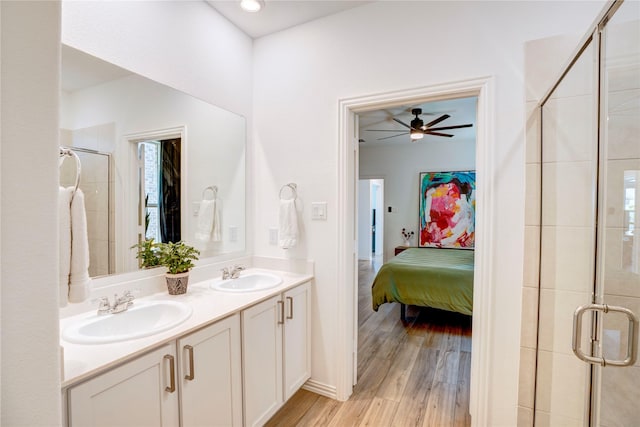 1113 Milfoil Dr, Justin, TX 76247 - full bathroom featuring a shower stall, double vanity, ensuite bathroom, and wood finished floors