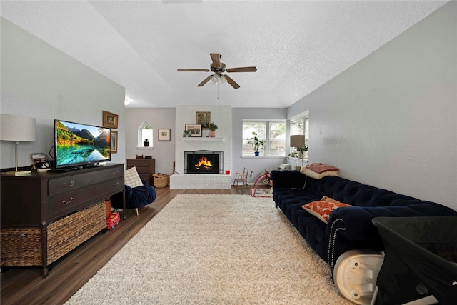 7828 Cardinal Ct 7824, North Richland Hills, TX 76180 - living area featuring wood finished floors, ceiling fan, a brick fireplace, and a textured ceiling
