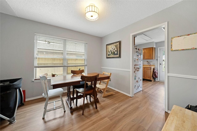 7828 Cardinal Ct 7824, North Richland Hills, TX 76180 - dining room with light wood-style floors and a textured ceiling