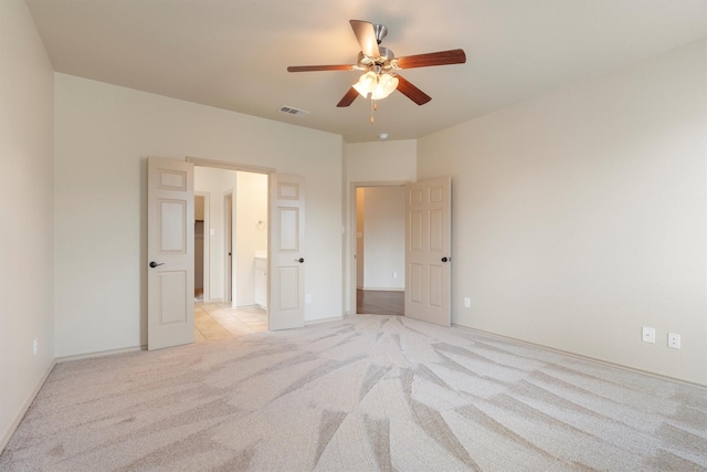 3228 Buckthorn Ln, Denton, TX 76226 - unfurnished bedroom featuring light carpet, ensuite bath, and a ceiling fan