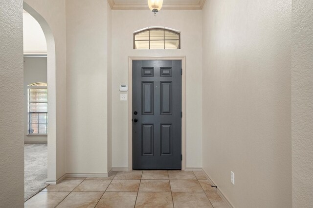 3228 Buckthorn Ln, Denton, TX 76226 - entrance foyer with arched walkways, light tile patterned floors, healthy amount of natural light, and crown molding