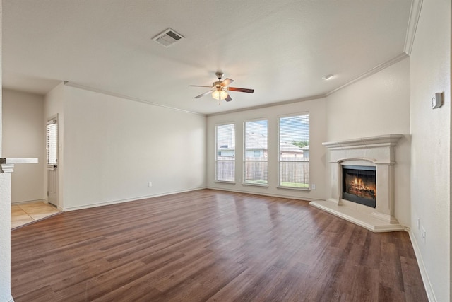 3228 Buckthorn Ln, Denton, TX 76226 - unfurnished living room featuring a high end fireplace, crown molding, ceiling fan, and wood finished floors