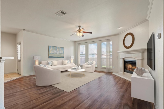 3228 Buckthorn Ln, Denton, TX 76226 - living room featuring a premium fireplace, crown molding, ceiling fan, and wood finished floors