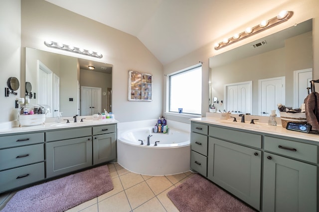 5872 Nathaniel Dr, Fort Worth, TX 76179 - full bathroom with two vanities, lofted ceiling, tile patterned flooring, and a whirlpool tub