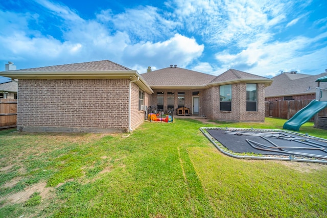 5872 Nathaniel Dr, Fort Worth, TX 76179 - back of property with brick siding, a fenced backyard, and a playground