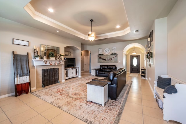 5872 Nathaniel Dr, Fort Worth, TX 76179 - living room with arched walkways, a tray ceiling, light tile patterned floors, a ceiling fan, and recessed lighting