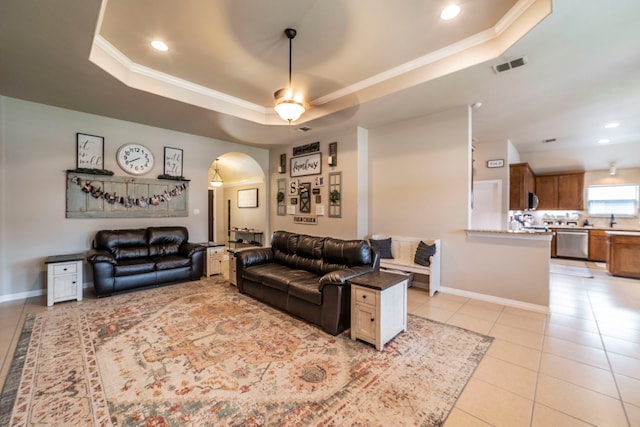 5872 Nathaniel Dr, Fort Worth, TX 76179 - living area featuring a raised ceiling, arched walkways, a ceiling fan, light tile patterned floors, and crown molding