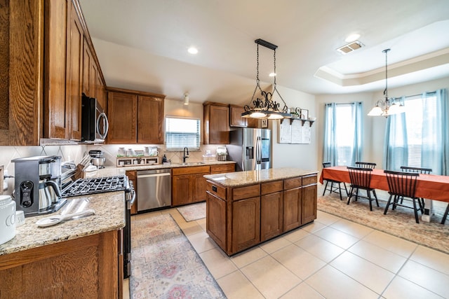 5872 Nathaniel Dr, Fort Worth, TX 76179 - kitchen featuring stainless steel appliances, healthy amount of natural light, a kitchen island, a chandelier, and recessed lighting
