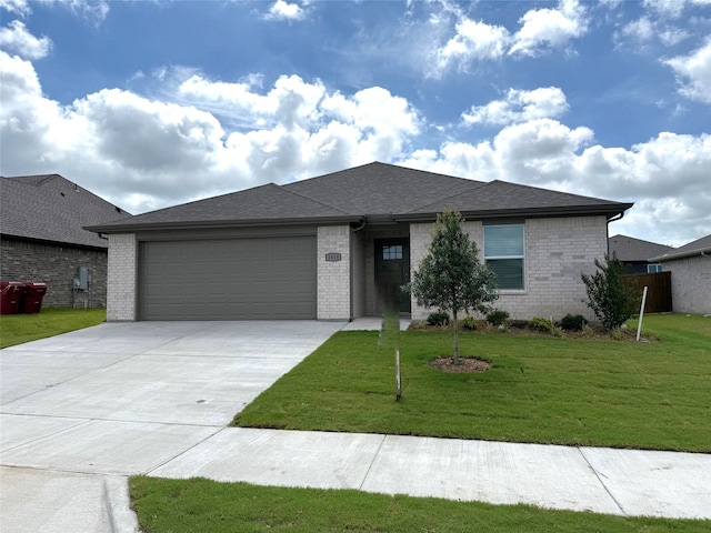 1819 Boxwood Dr, Sherman, TX 75092 - view of front of house featuring an attached garage, driveway, a front lawn, and brick siding