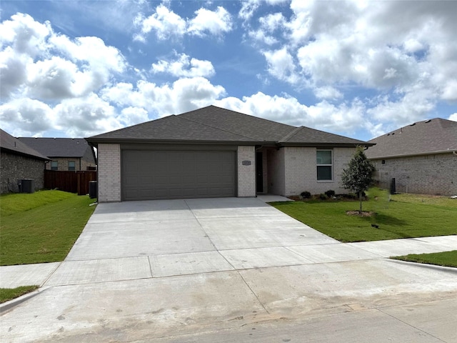 1819 Boxwood Dr, Sherman, TX 75092 - view of front of property featuring brick siding, a garage, driveway, and roof with shingles