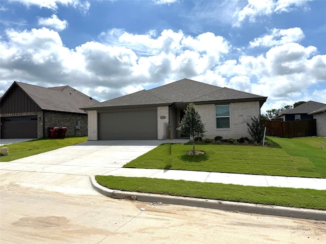 1819 Boxwood Dr, Sherman, TX 75092 - view of front of home with brick siding, a garage, driveway, and a shingled roof