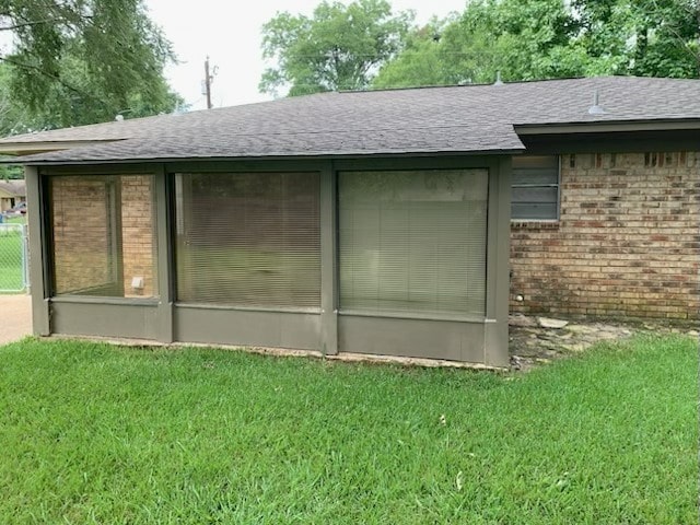 304 Lakeview St, Whitehouse, TX 75791 - view of side of home with brick siding, a shingled roof, a sunroom, and a lawn