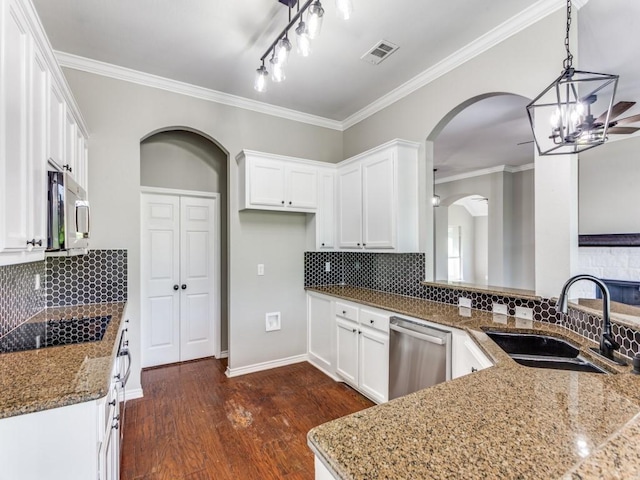 3409 Doris Walker Trl, Burleson, TX 76028 - kitchen with stainless steel appliances, arched walkways, dark stone countertops, white cabinets, and ornamental molding
