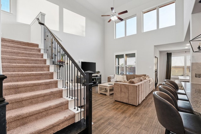 3804 Driftwood Ln, Northlake, TX 76226 - living area with a ceiling fan, stairs, wood finished floors, and a towering ceiling