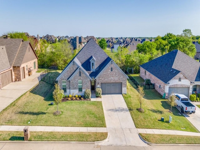 2112 Deer Run, Gunter, TX 75058 - view of front of home with a residential view, concrete driveway, brick siding, and a front lawn