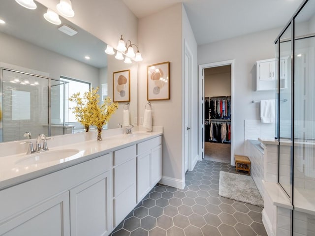 2112 Deer Run, Gunter, TX 75058 - full bathroom featuring a shower stall, double vanity, a bath, a walk in closet, and recessed lighting