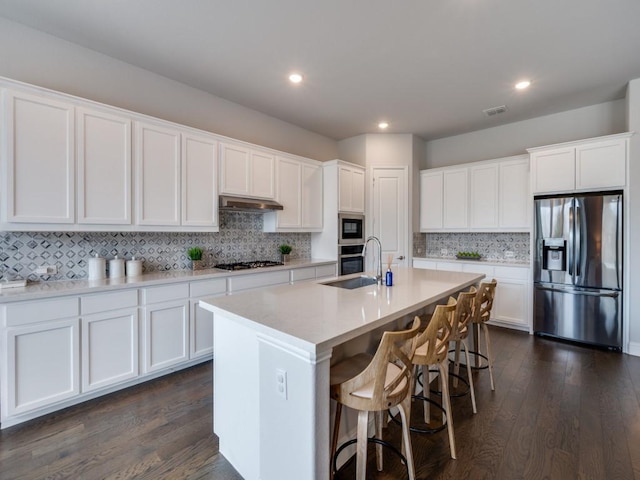 2112 Deer Run, Gunter, TX 75058 - kitchen featuring appliances with stainless steel finishes, tasteful backsplash, dark wood-style flooring, white cabinetry, and recessed lighting