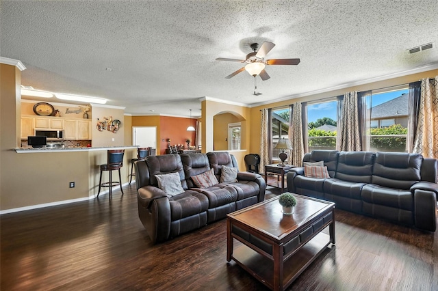 1906 Walnut Hills Ln, Mansfield, TX 76063 - living area featuring ornamental molding, a textured ceiling, ceiling fan, dark wood finished floors, and arched walkways