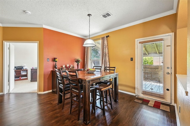 1906 Walnut Hills Ln, Mansfield, TX 76063 - dining area featuring wood finished floors, a textured ceiling, and crown molding
