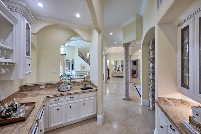 5 Savannah Ridge Dr, Frisco, TX 75034 - kitchen with light stone counters, white cabinets, decorative columns, crown molding, and recessed lighting