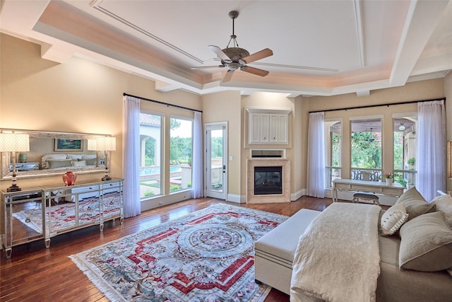 5 Savannah Ridge Dr, Frisco, TX 75034 - living room featuring ceiling fan, a glass covered fireplace, hardwood / wood-style flooring, and crown molding