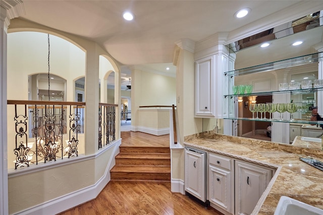 5 Savannah Ridge Dr, Frisco, TX 75034 - bar featuring light wood-type flooring, ornamental molding, ceiling fan, recessed lighting, and arched walkways