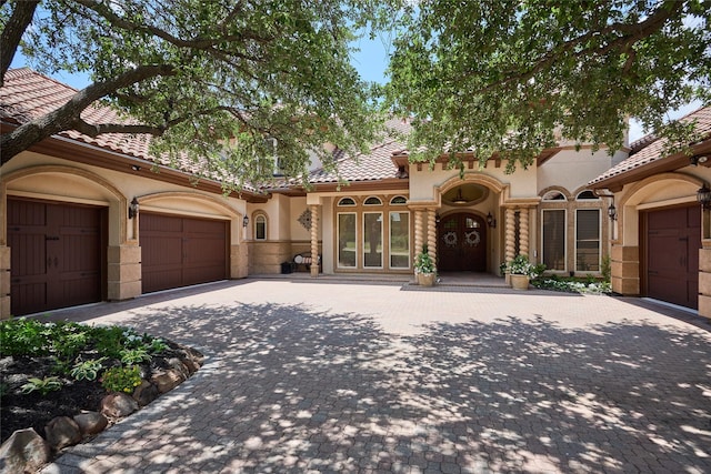 5 Savannah Ridge Dr, Frisco, TX 75034 - mediterranean / spanish house with stucco siding, decorative driveway, a tiled roof, a garage, and french doors