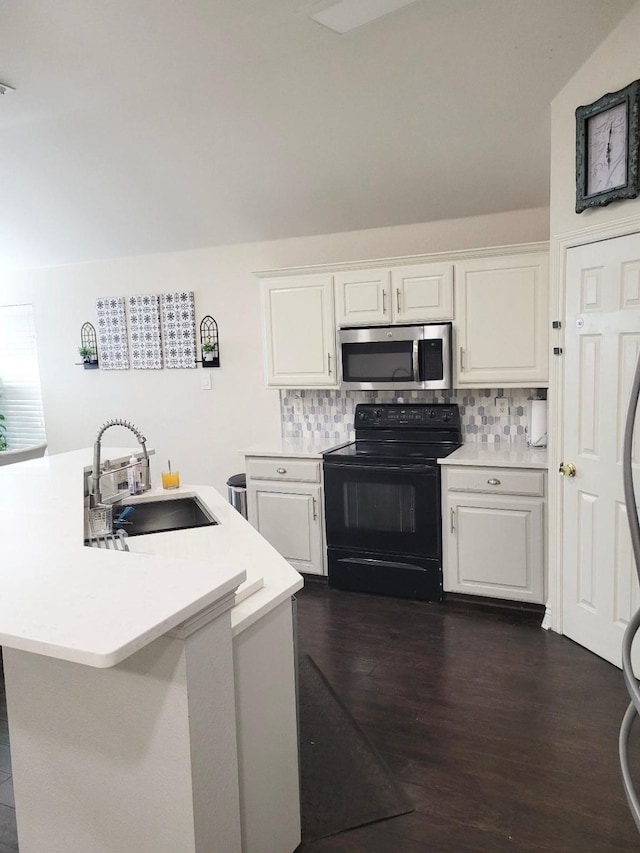 700 Auburndale Dr, Euless, TX 76040 - kitchen with stainless steel microwave, black electric range oven, light countertops, backsplash, and white cabinetry