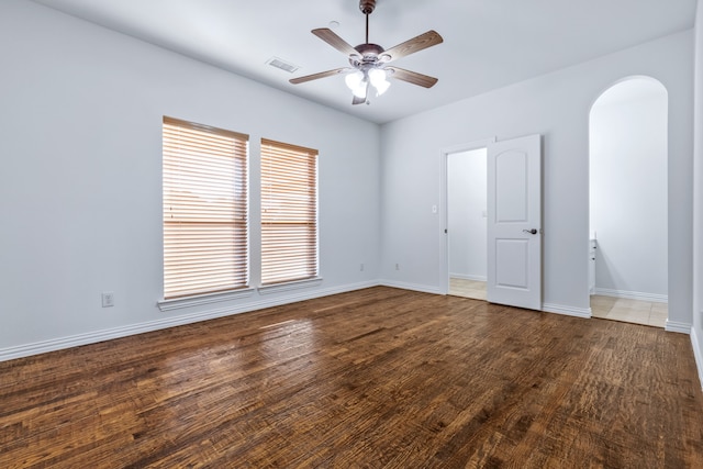 4205 Midpark Ln, Plano, TX 75074 - unfurnished room featuring arched walkways, ceiling fan, and wood finished floors