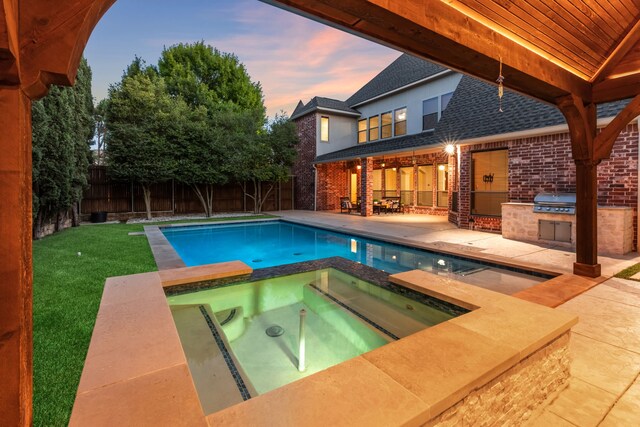 4205 Midpark Ln, Plano, TX 75074 - view of swimming pool with area for grilling, a fenced backyard, a patio area, and a pool with connected hot tub