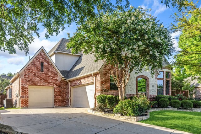 4205 Midpark Ln, Plano, TX 75074 - view of front of house with a garage, roof with shingles, driveway, brick siding, and a front lawn