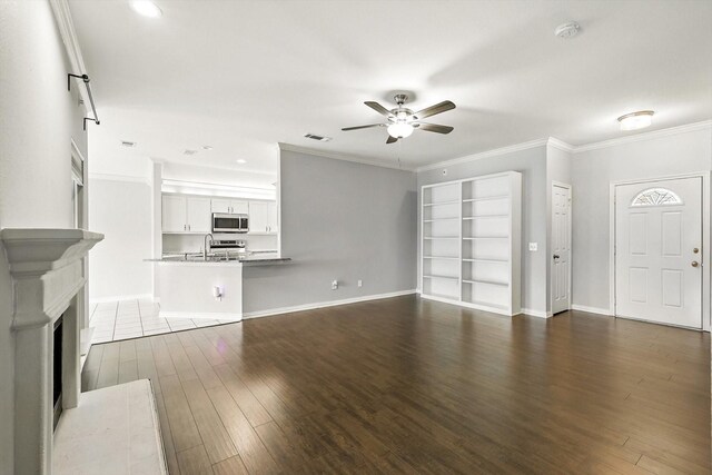 638 Lakeshore Blvd, Oak Point, TX 75068 - unfurnished living room featuring a ceiling fan, wood finished floors, ornamental molding, recessed lighting, and built in features